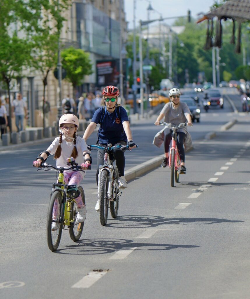 bicyclists, people, casual, helmet, woman, child, girl, running, bikes, track, lane, street, urban, sport, recreation, healthy, ecological